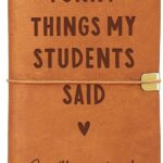 Brown faux leather journal with "Funny Things My Students Said" engraved on the cover, closed with an elastic band.
