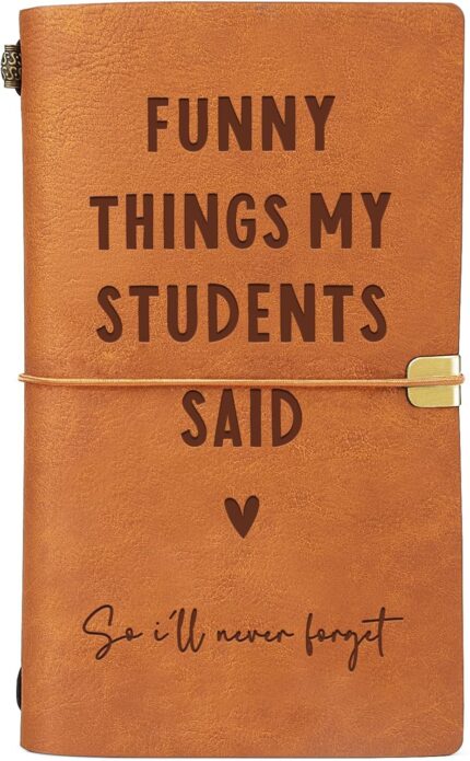 Brown faux leather journal with "Funny Things My Students Said" engraved on the cover, closed with an elastic band.