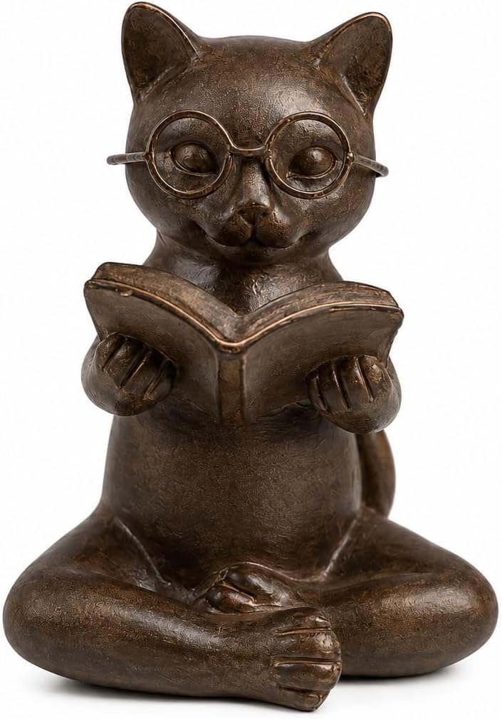 Bronze resin figurine of a cat with glasses, sitting cross-legged and reading an open book, on a light surface.