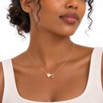 Close-up of a Turandoss 18K gold plated heart initial necklace with a letter A pendant on a white background.