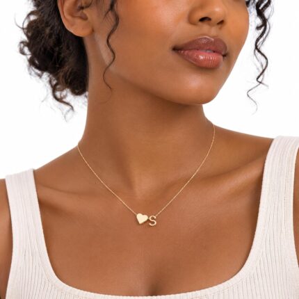 Close-up of a Turandoss 18K gold plated heart initial necklace with a letter A pendant on a white background.