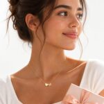 Close-up of a Turandoss 18K gold plated heart initial necklace with a letter A pendant on a white background.