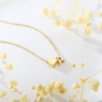 Close-up of a Turandoss 18K gold plated heart initial necklace with a letter A pendant on a white background.