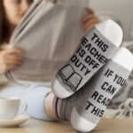 White 20 OZ insulated tumbler with teacher quote, funny socks, and a pen bag, all in a gift box.