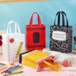A set of 24 colorful Wesnoy reusable non-woven tote bags with handles, featuring various school-themed designs like crayons a